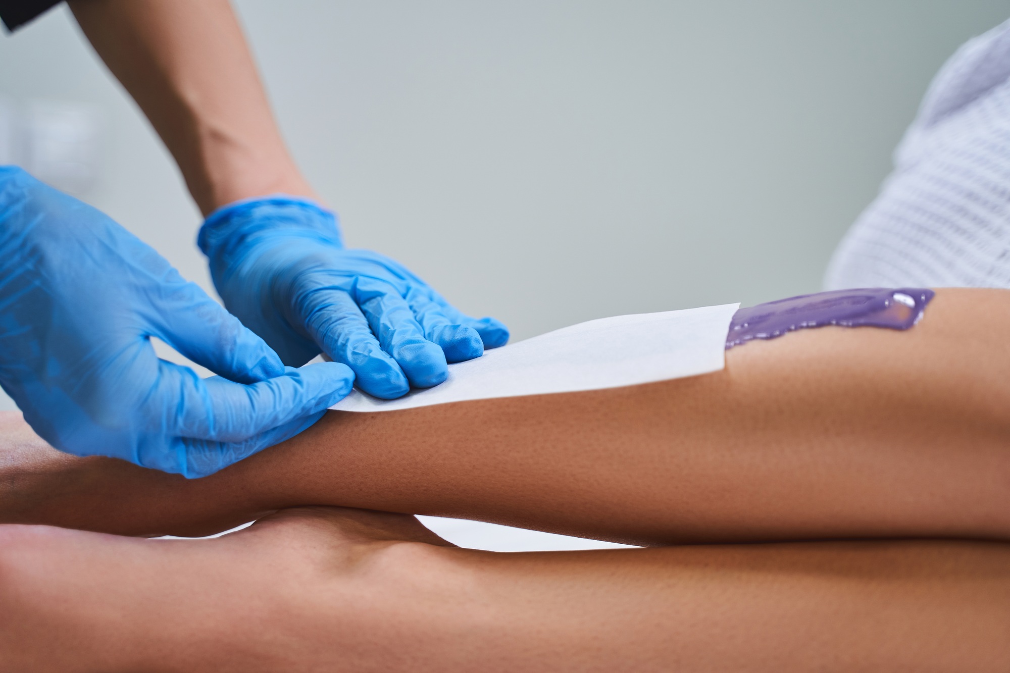 Cropped photo of waxing procedure at cosmetologist stock photo